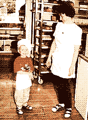 Little me in a tiny baker’s hat, grinning next to my mum between the bread racks of my parents’ bakery.